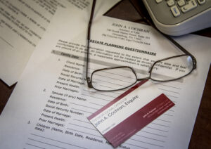 What makes a great estate attorney? An image of an estate planning questionnaire and business card.