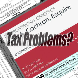 Avoid Three Common Problems to Minimize Tax Pains. 
An image of the red and white John A. Cochran, Esq. business card with tax forms.
