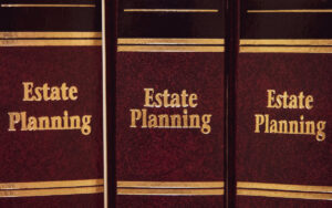 Image of estate planning law books in dark red and gold trim. 